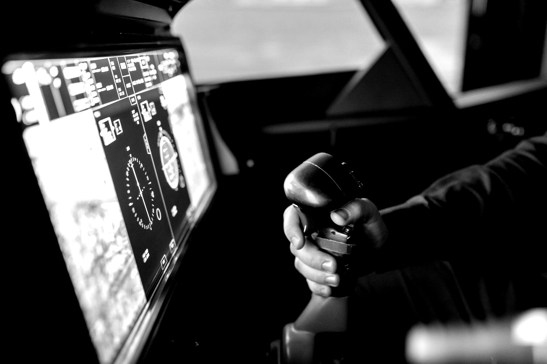 Operator hand on a mission-control stick